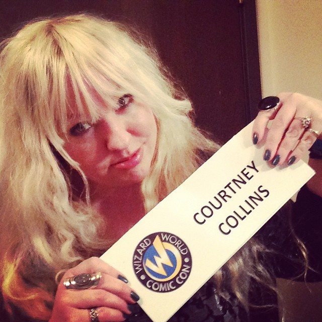 Woman with blonde hair holding a "COURTNEY COLLINS" name tag with Wizard World Comic Con logo.